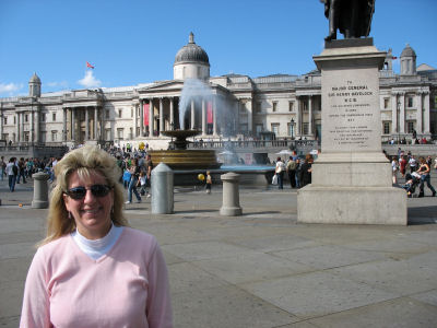 Fountains and statues in Trafalgar Square. The National Gallery is in the background.